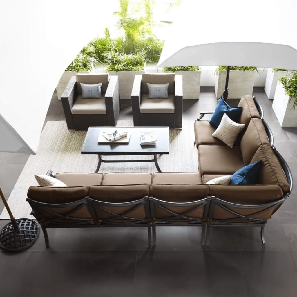 Outdoor Patio Furniture Set With A Sectional Sofa, Chairs, And A Coffee Table On A Patio.