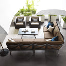 Outdoor Patio Furniture Set With A Sectional Sofa, Chairs, And A Coffee Table On A Patio.