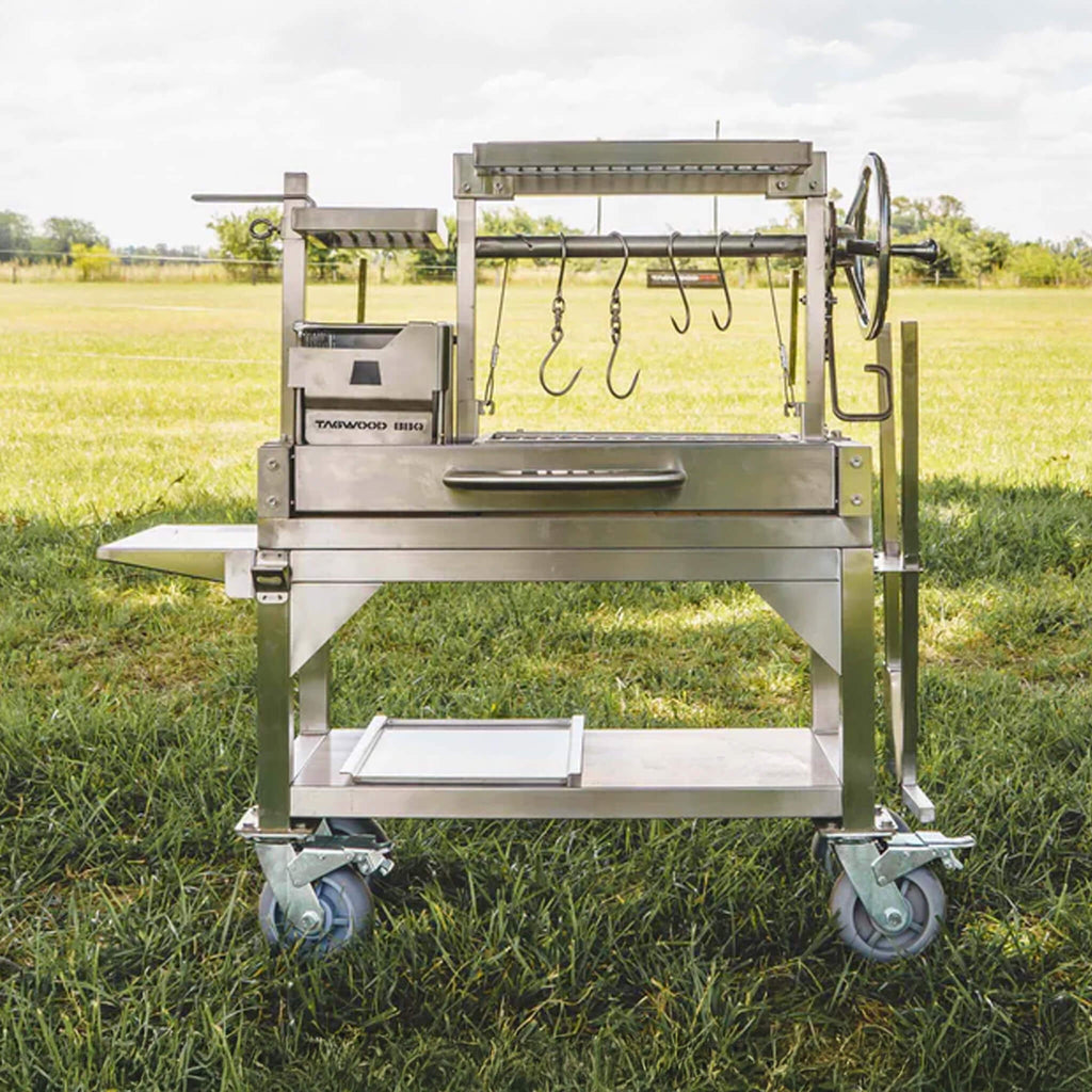 Tagwood BBQ Argentine Santa Maria Wood Fire And Charcoal Gaucho Grill BBQ03SS Mini SAK35620 - Lifestyle On Grass Front View