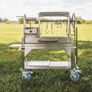Tagwood BBQ Argentine Santa Maria Wood Fire And Charcoal Gaucho Grill BBQ03SS Mini SAK35620 - Lifestyle On Grass Front View
