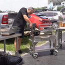 Tagwood BBQ Argentine Santa Maria Wood Fire And Charcoal Gaucho Grill BBQ03SS Mini SAK35620 Saksby - Lifestyle With Man Beside It