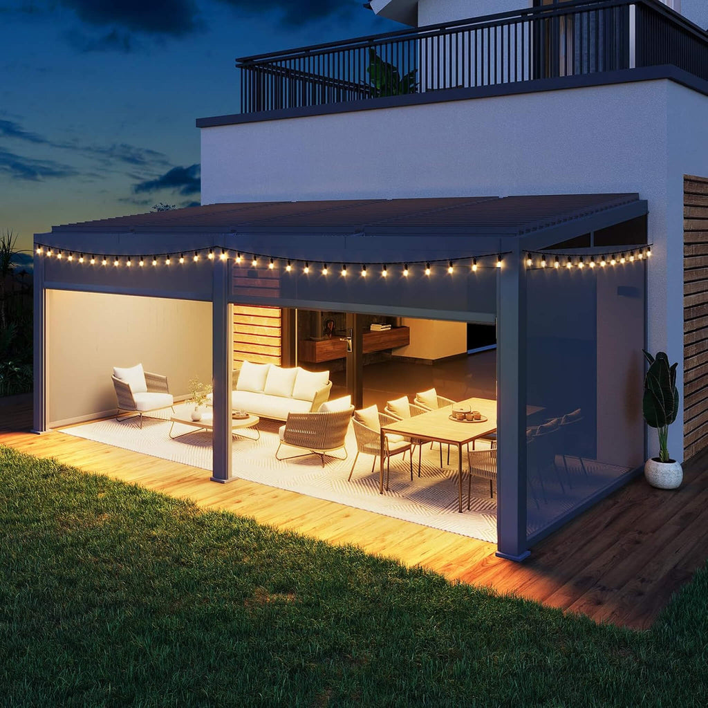 [10X20FT] Luxury Wall-Mounted Louvered Pergola With Pull-Down Screens (SAK91537) - Saksby Wholesale - Lifestyle Front Left View With Lights Mounted To Building Nighttime