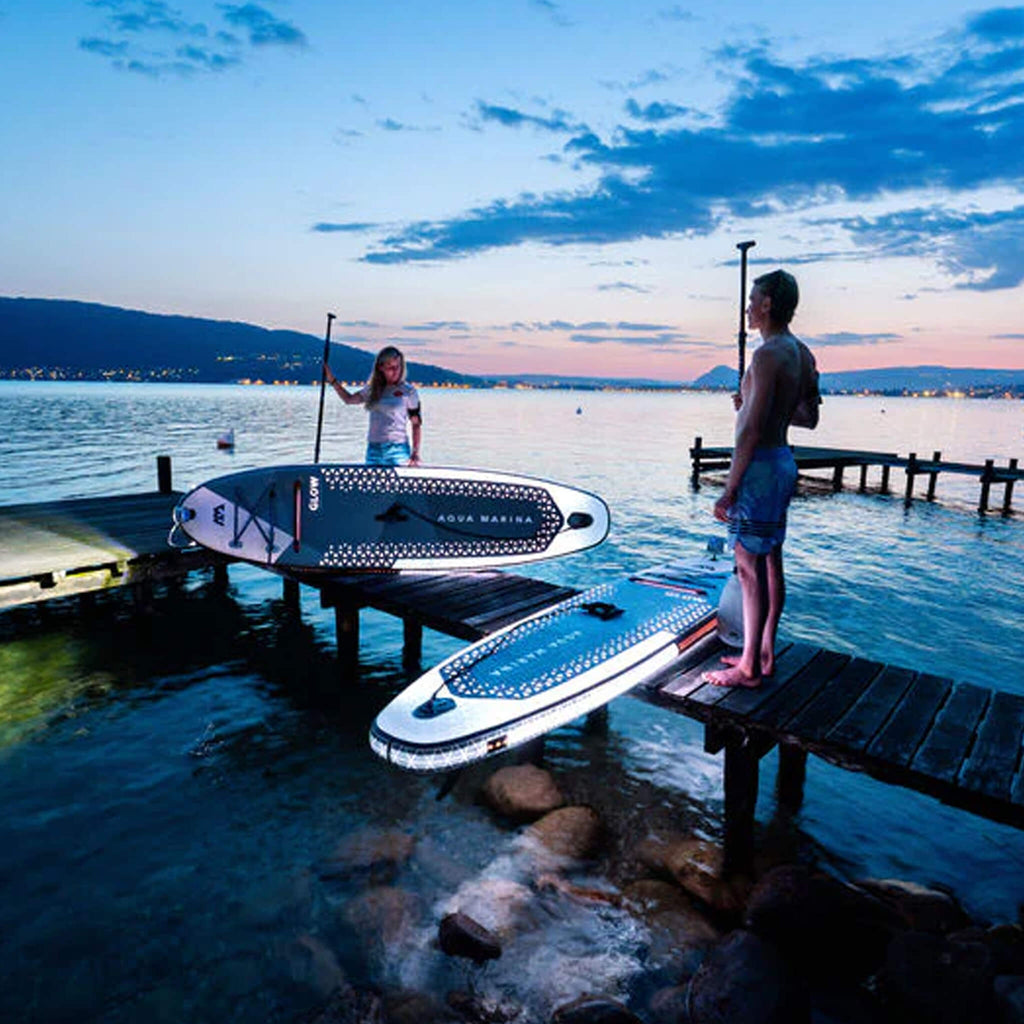 Aqua Marina Glow 10FT All-Around ISUP With Ambient Light System And Safety Leash [BT-24GL] (SAK48269) - Saksby Wholesale - Lifestyle With Two Person Night View