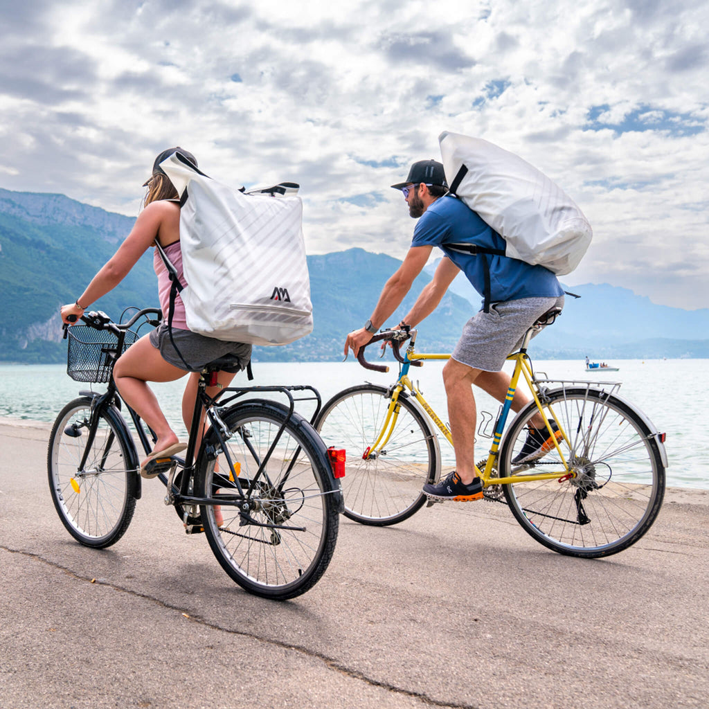 Aqua Marina Halve Ultra-Light Packayak™ 2-Person Kayak With DWF Deck [Paddle Excluded] [HA-398] (SAK41876) - Saksby Wholesale - Lifestyle With Two People Carrying On Bike