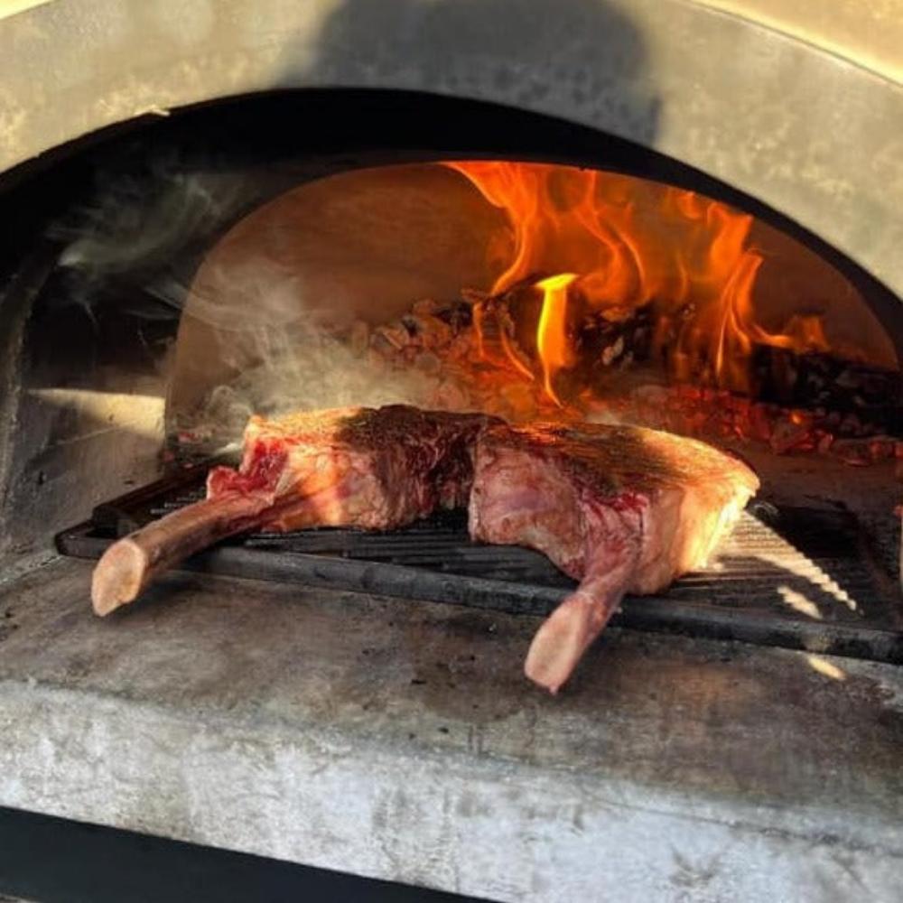 Chicago Brick Oven-750 Tailgater Wood Fired Pizza Oven On Trailer, 48" [CBO-O] (SAK82581) - Saksby Wholesale - Grilling Meat In Action