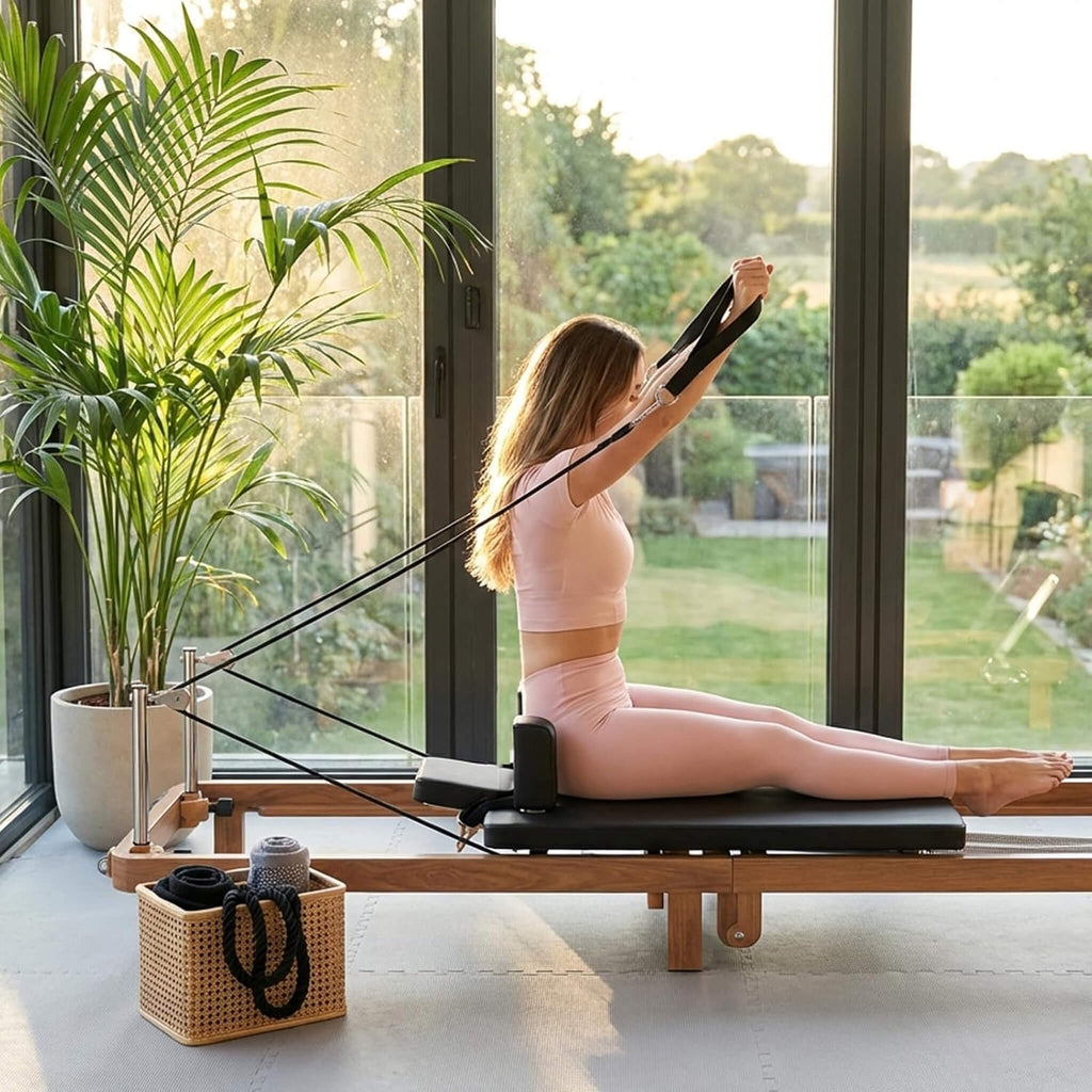 Foldable Dual Resistance Pilates Reformer With Jumpboard (SAK83914) - Saksby Wholesale - Lifestyle With Woman