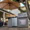 Kokomo Grills Maui BBQ Island With 33 Inch Round Bar LED Lights And Built In BBQ SAK25961 - Lifestyle On Backyard Patio Bottom Up View
