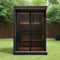 Wooden Sauna With Black Exterior Doors In A Garden Setting