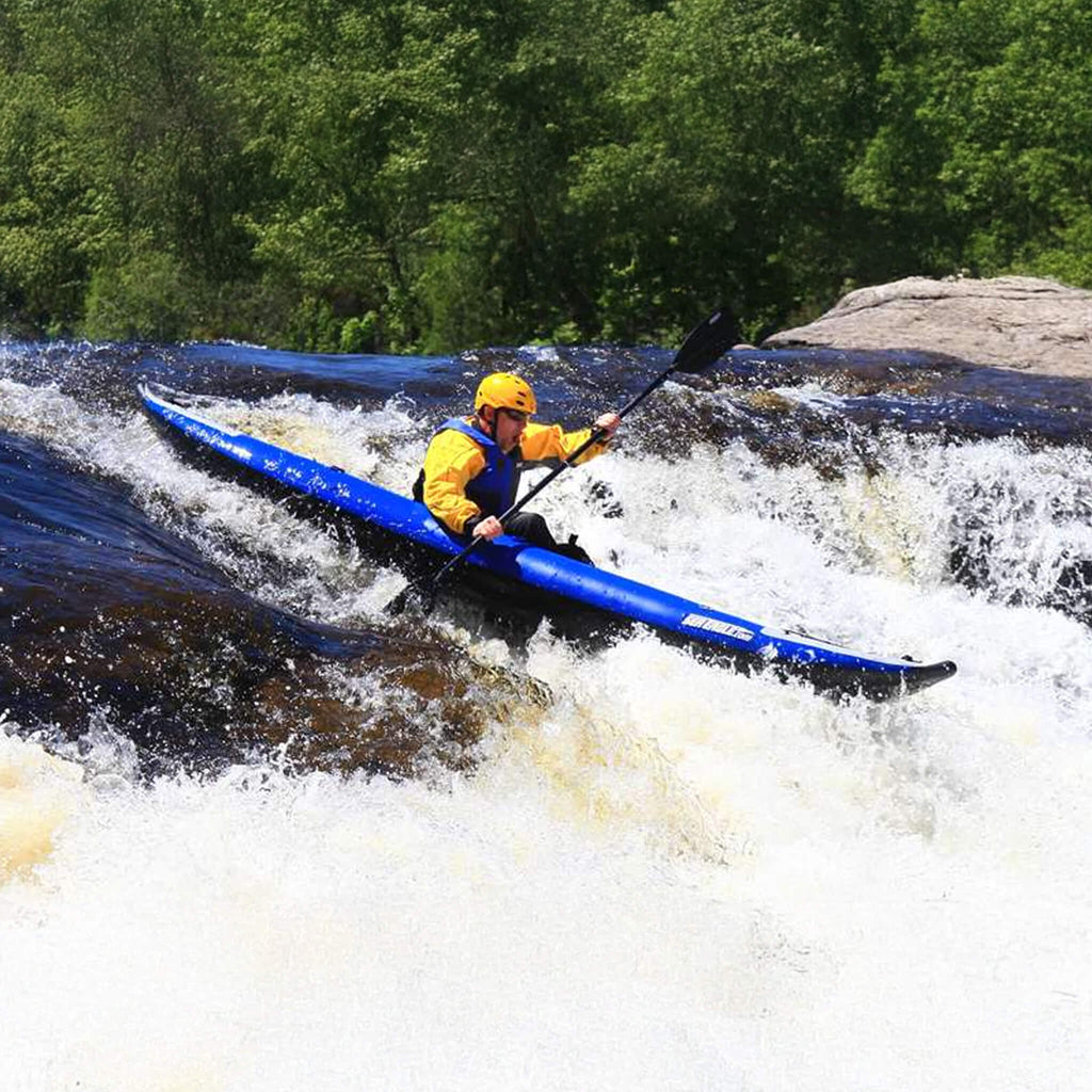 Person Kayaking In White Water Rapids With A Blue Kayak And Yellow Helmet - Saksby Wholesale