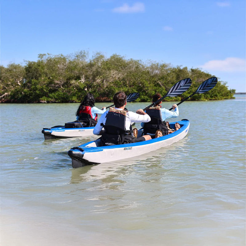 Two Kayaks With People Paddling On A Calm Body Of Water With Trees In The Background - Saksby Wholesale