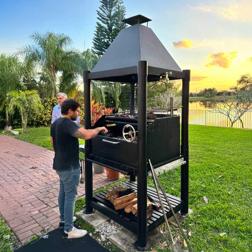 Tagwood BBQ Argentine Santa Maria Wood Fire & Charcoal Gaucho Grill [BBQ02SIB] (SAK86741) - Saksby Wholesale - Lifestyle Image In Outdoor Setup