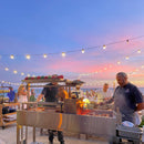 Tagwood BBQ Argentine Santa Maria Wood-Fire Charcoal Gaucho Grill BBQ06SS - SAK62378 - Lifestyle in Front of Ocean