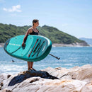 Aqua Marina Breeze 9FT Green Compact Inflatable SUP With Drop Stitch Light Technology [BT-23BRP] (SAK68745) - Saksby Wholesale - Woman Standing On Shore Side View