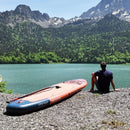 Aqua Marina Monster 12FT All-Around ISUP Sky Glider With Swift Attach Center Fin [BT-23MOP] (SAK56240) - Saksby Wholesale - Lifestyle With Man Sitting Beside In Front Of Lake