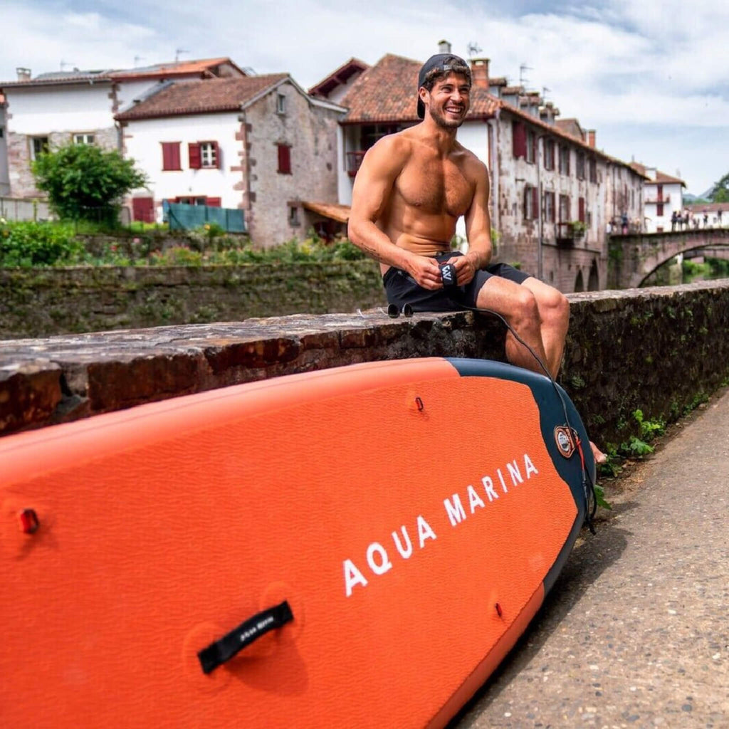 Aqua Marina Monster 12FT All-Around ISUP Sky Glider With Swift Attach Center Fin [BT-23MOP] (SAK56240) - Saksby Wholesale - Lifestyle With Man Sitting Next To Paddleboard