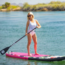 Pop Board Co. Inflatable Board 10'6 Royal Hawaiian Pink/Black (SAK36410) - Saksby Wholesale - Lifestyle Image In The Sea With Person Standing